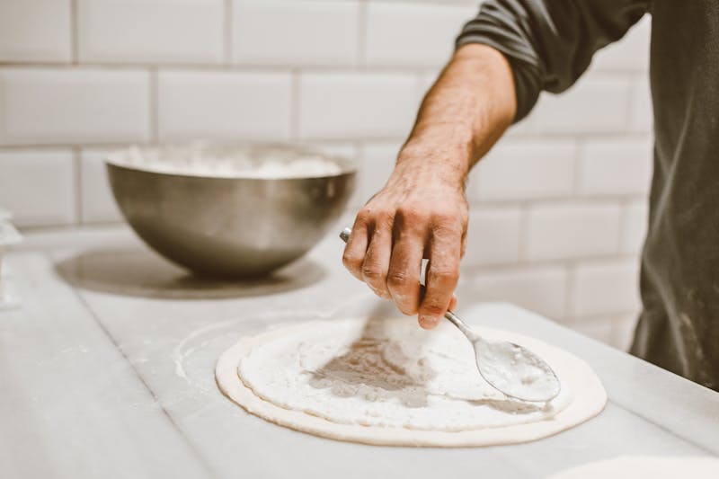 pizza lucs artisan team making pizza by hand